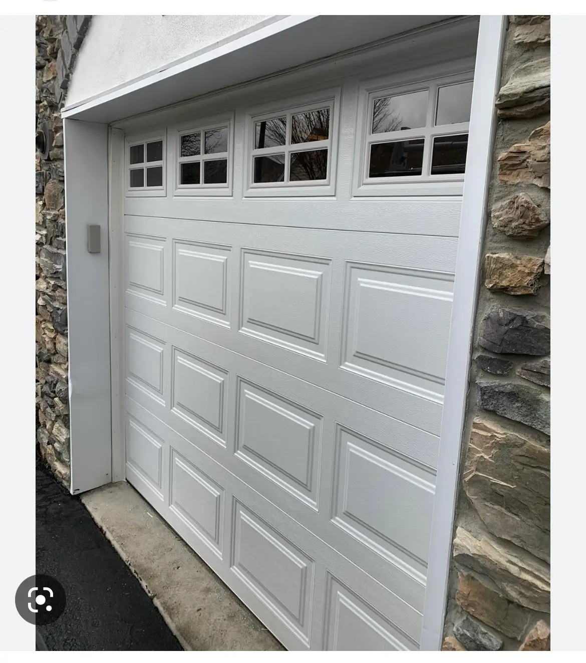 Small garage door repair. White garage door with four 4x4 windows.